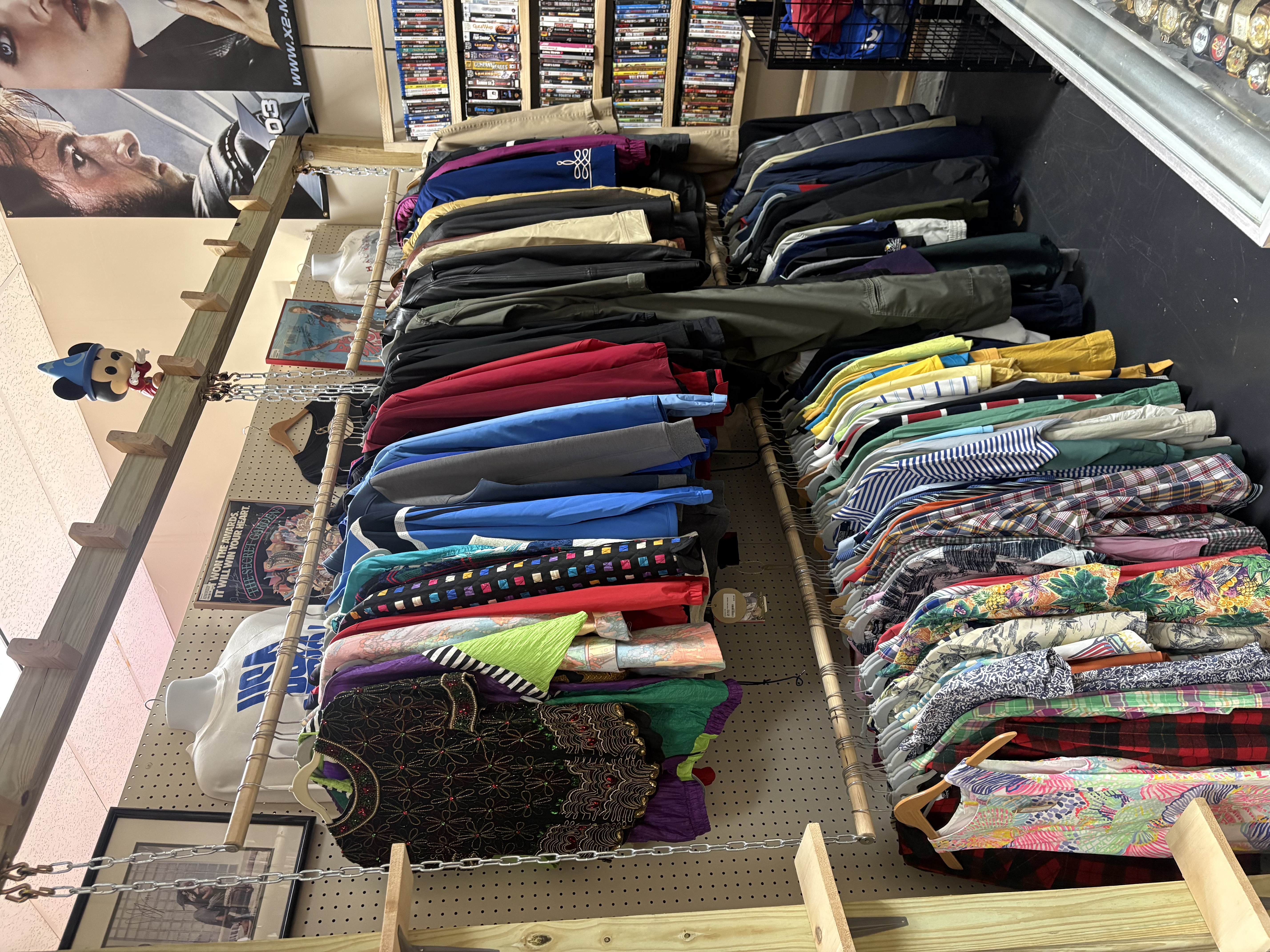 Vintage clothing, jackets, hats, and sports jerseys on racks
